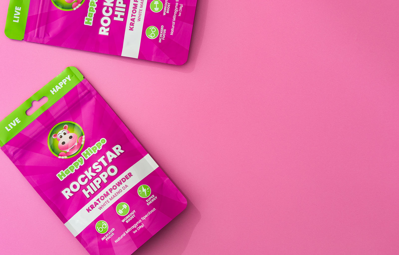 Featured Image depicting two 4oz packets of Happy Hippo branded kratom powder against a pink background.