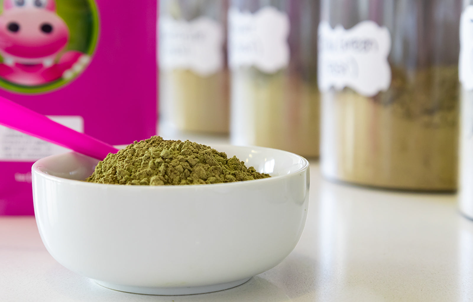 Featured Image depicting a bowl filled with Happy Hippo branded Green Maeng Da (Hyper Hippo) Kratom Powder