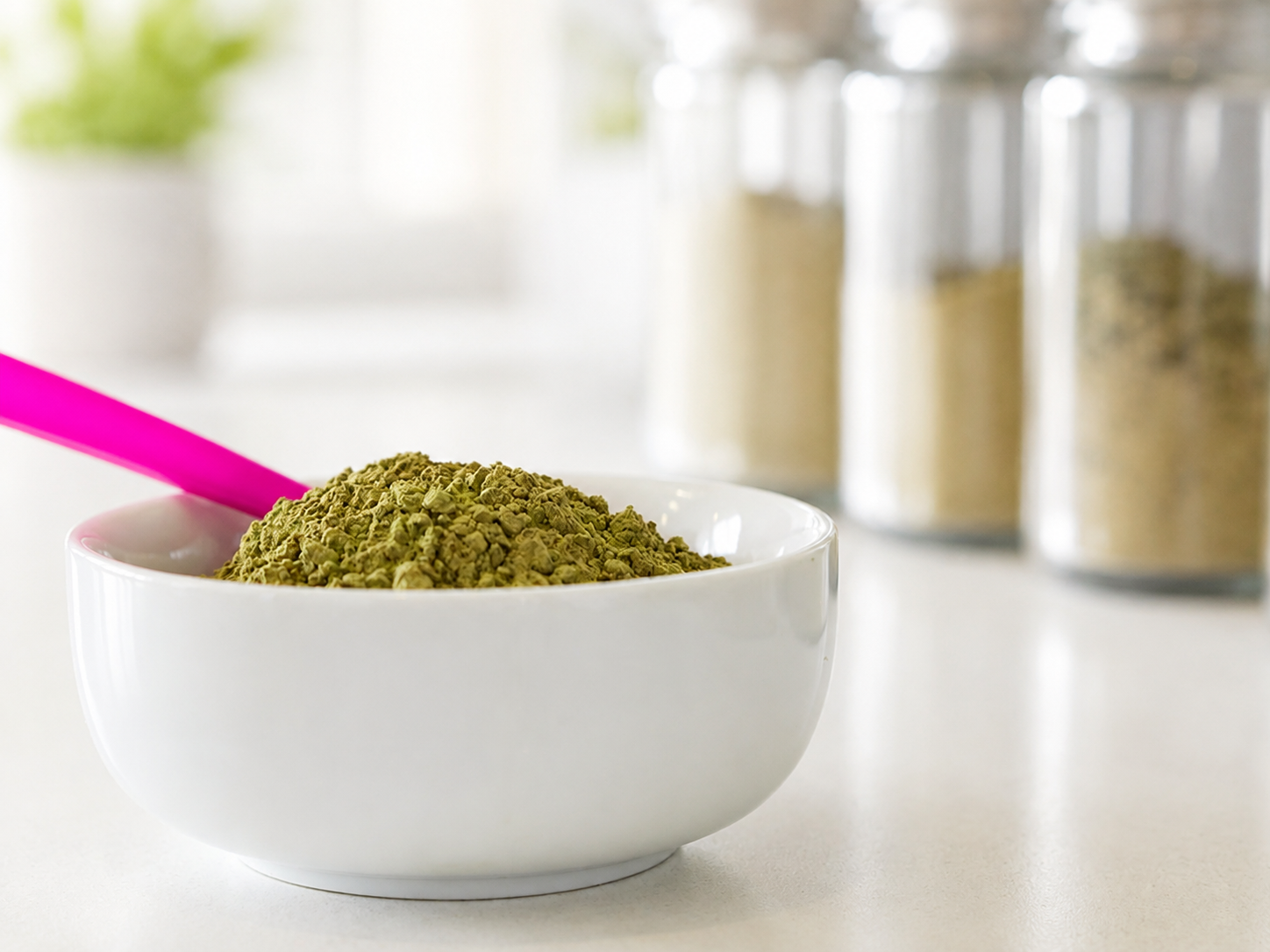 Kratom powder displayed in a white bowl with a pink scoop