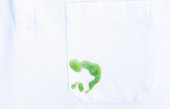 Featured image depicting a white shirt sitting on a white counter top. The shirt clearly has a big green kratom stain.