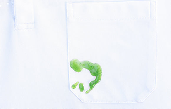 Featured image depicting a white shirt sitting on a white counter top. The shirt clearly has a big green kratom stain.