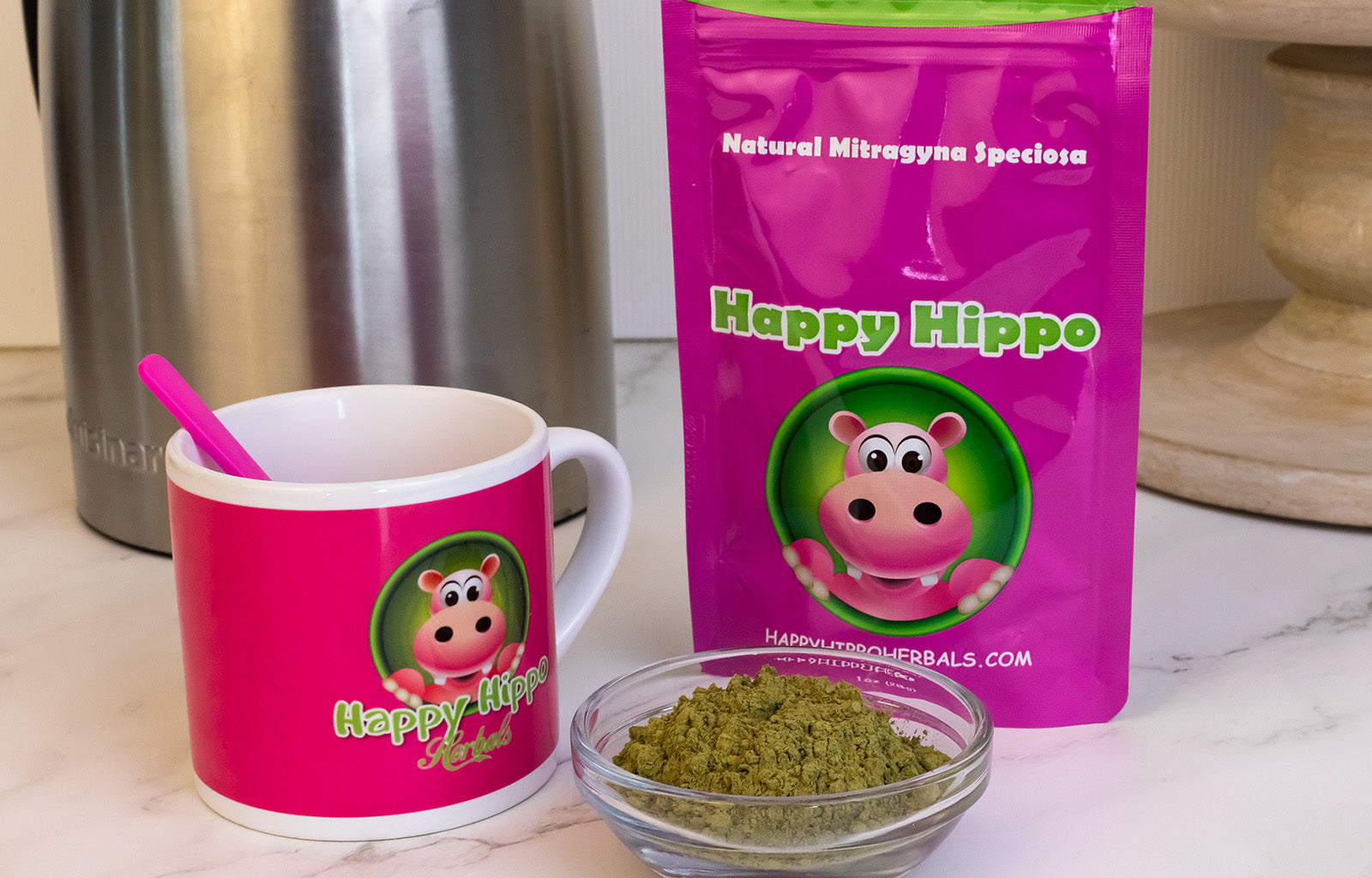 Featured image depicting a small glass ramekin containing loose kratom powder, next to which sits a tea cup, and a 1oz packet of Happy Hippo branded green maeng da kratom powder