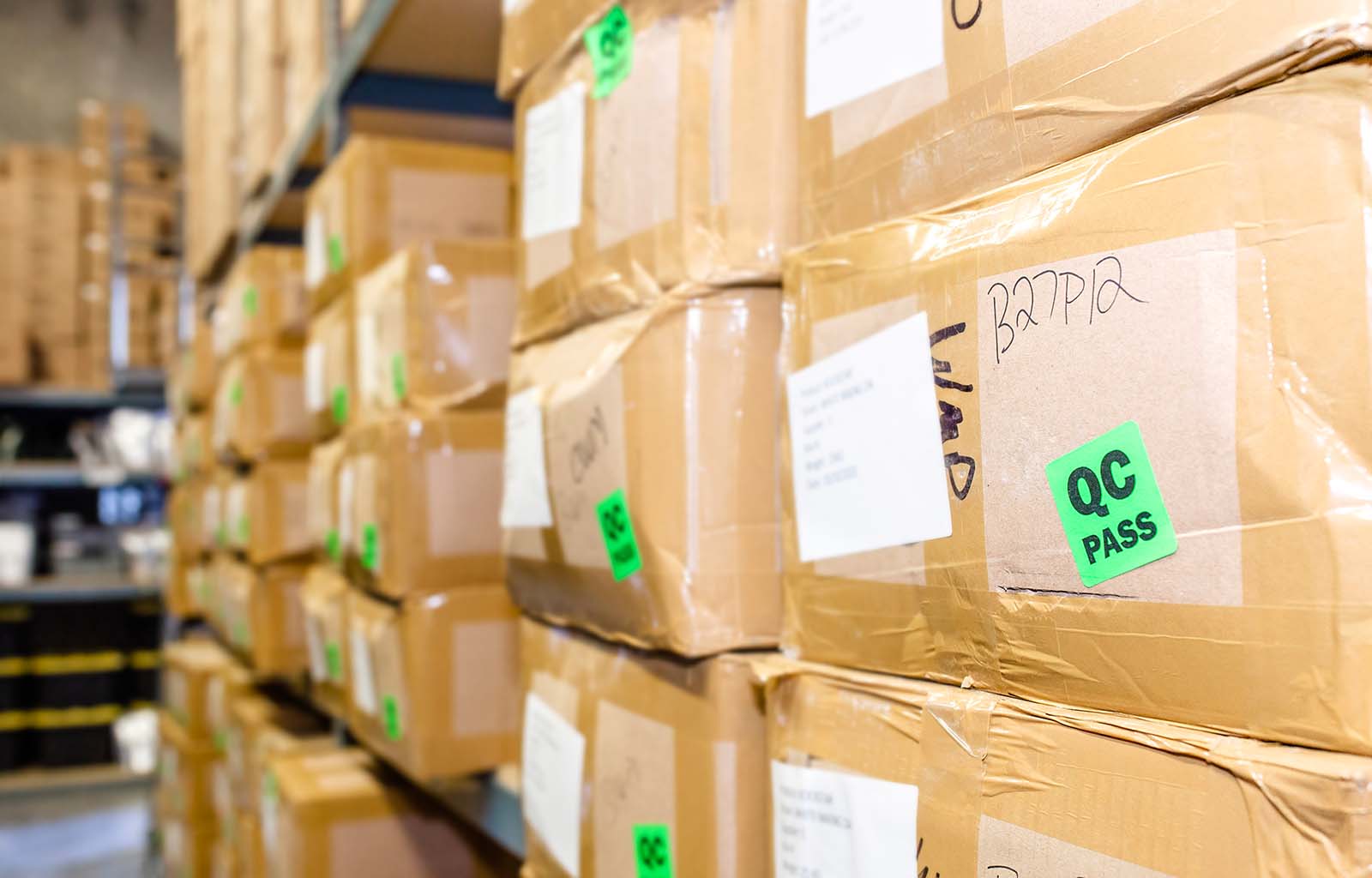 Featured image depicting warehouse shelving, filled with boxes of kratom (each with 1 kilo of quality, lab-tested bulk kratom) ready to ship to customers buying kratom bulk.